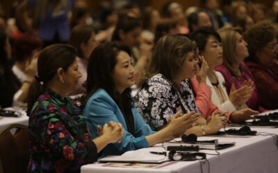 Attendees listening and clapping at Dr. Jun Sook Moon's conference event, themed "Peace Begins in the Home".