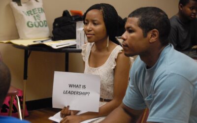 Two individuals attentively participating in a discussion about leadership.