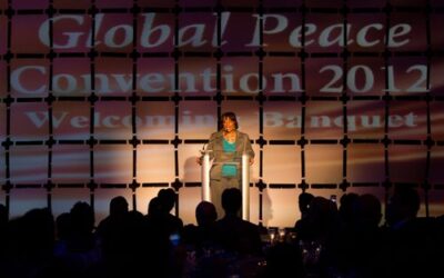 A woman speaks on stage at the global peace convention 2012.