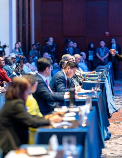 A man is giving a speech at the Global Peace Convention.