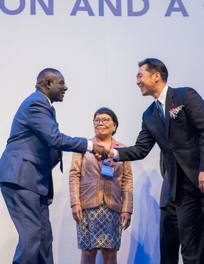 Two men shaking hands at the Global Peace Convention.