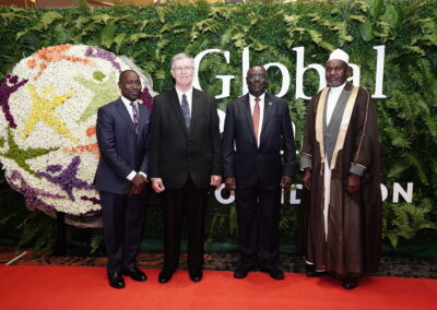 Four men in suits standing in front of a red carpet at the Awards Gala.
