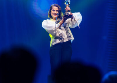 A woman holding an award at the Awards Gala.