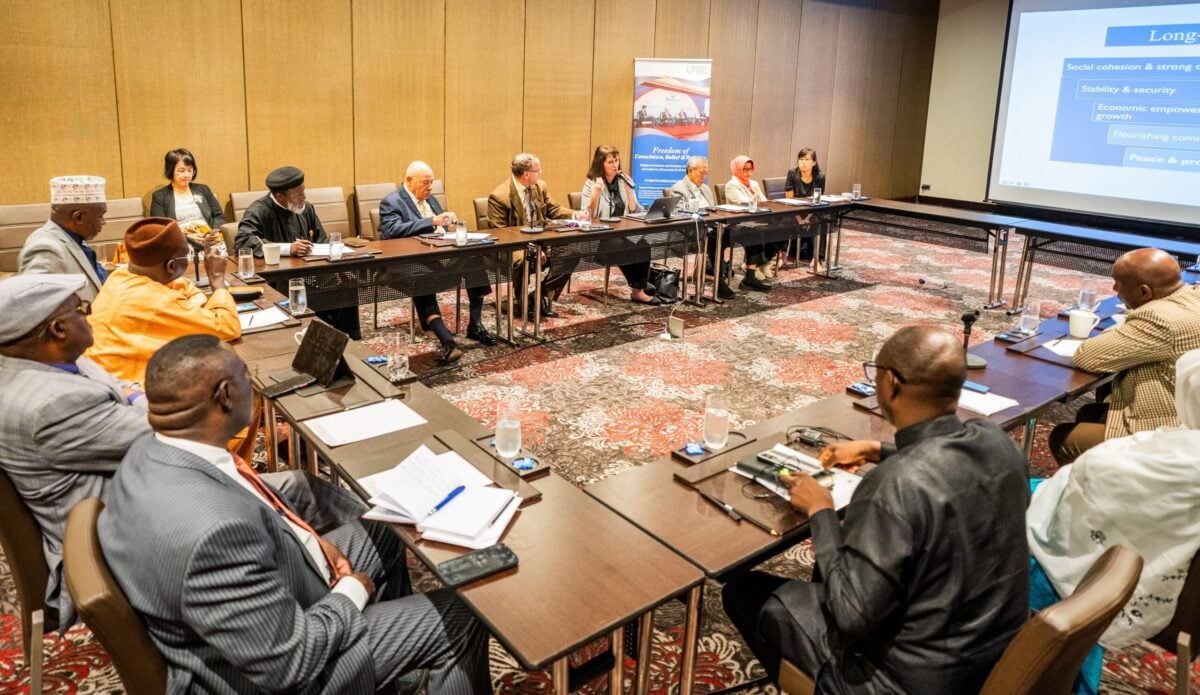 A religious freedom roundtable: A gathering of individuals, assembled in a conference room, engaging in discussions around a table.
